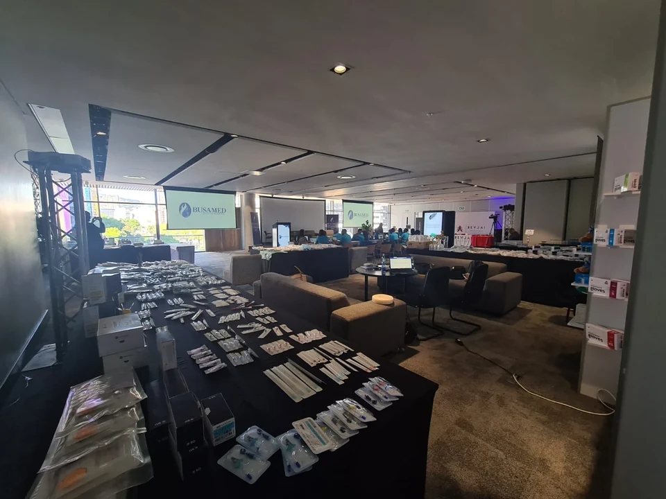 Product sample tables and meeting areas prepared within the Busamed conference room.