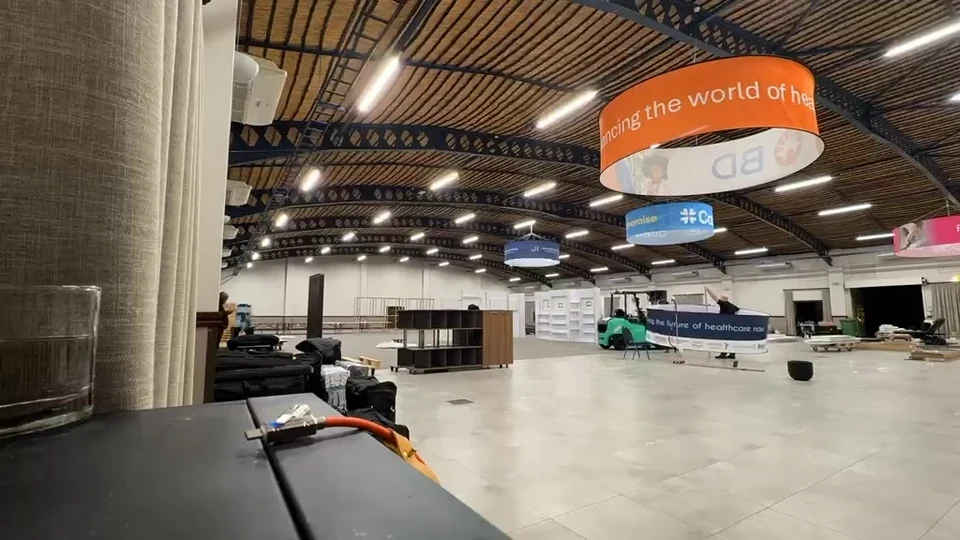 The UNITE venue during setup, with exhibition stands being assembled.